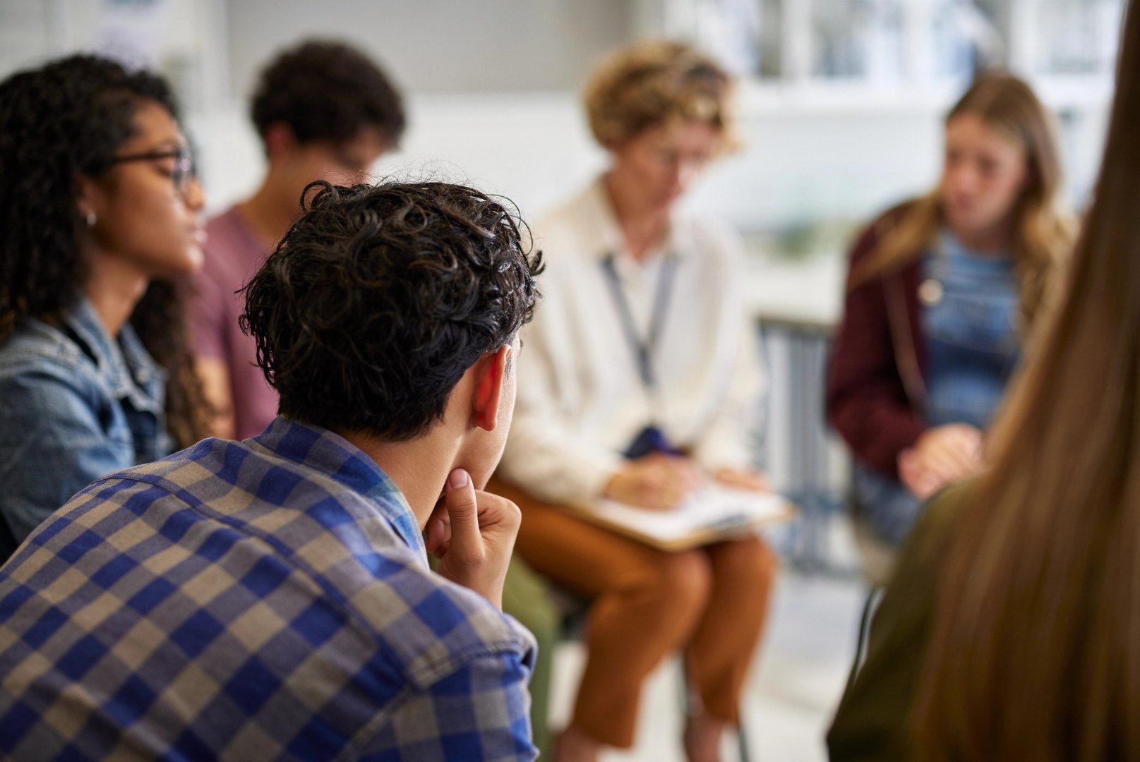 A student listening in a classroom conversation circle